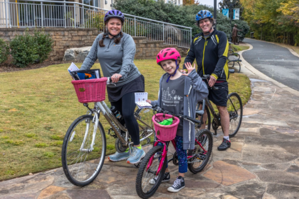 Family with colorful helmets and bikes