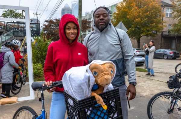 Two bicyclists with ET costume
