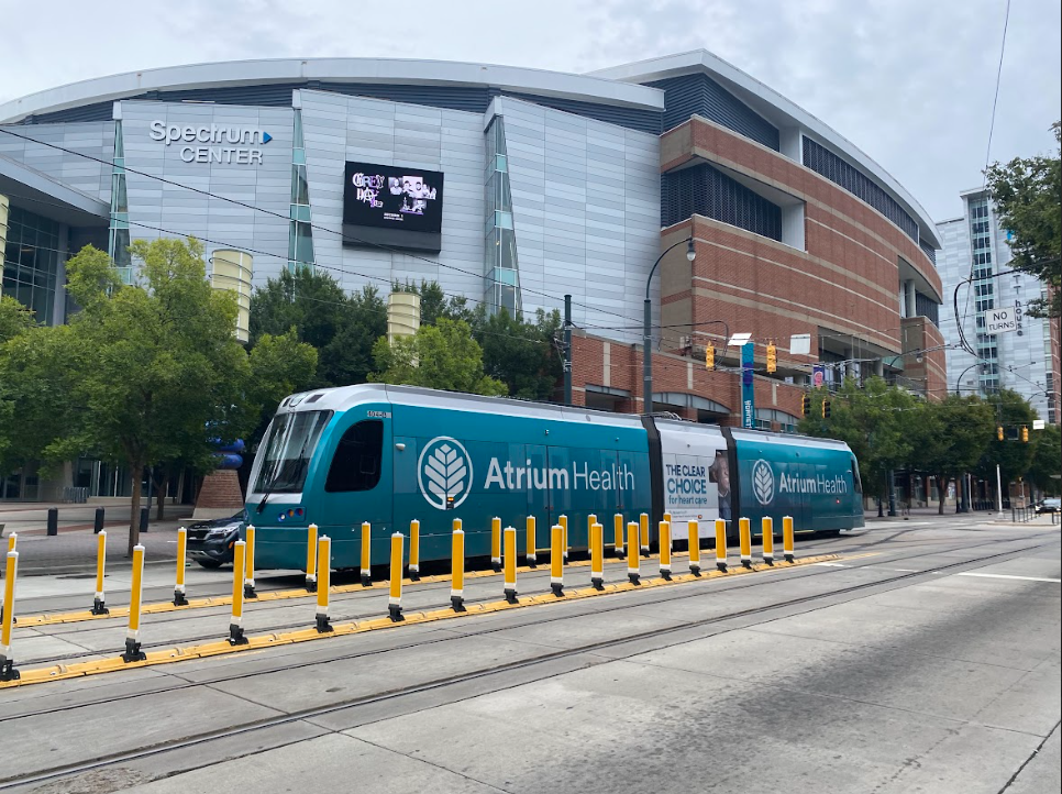 A streetcar passes in front of the Spectrum Center