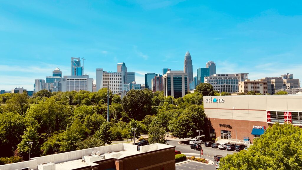 Charlotte’s Strategic Mobility Plan could make the city more equitable. Here's how. At Home store with Charlotte skyline in the background.
