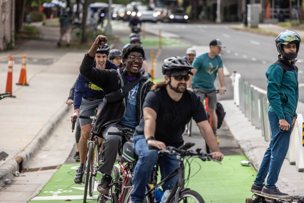 A group of bicyclists rides to celebrate the opening of the Uptown Cyclelink