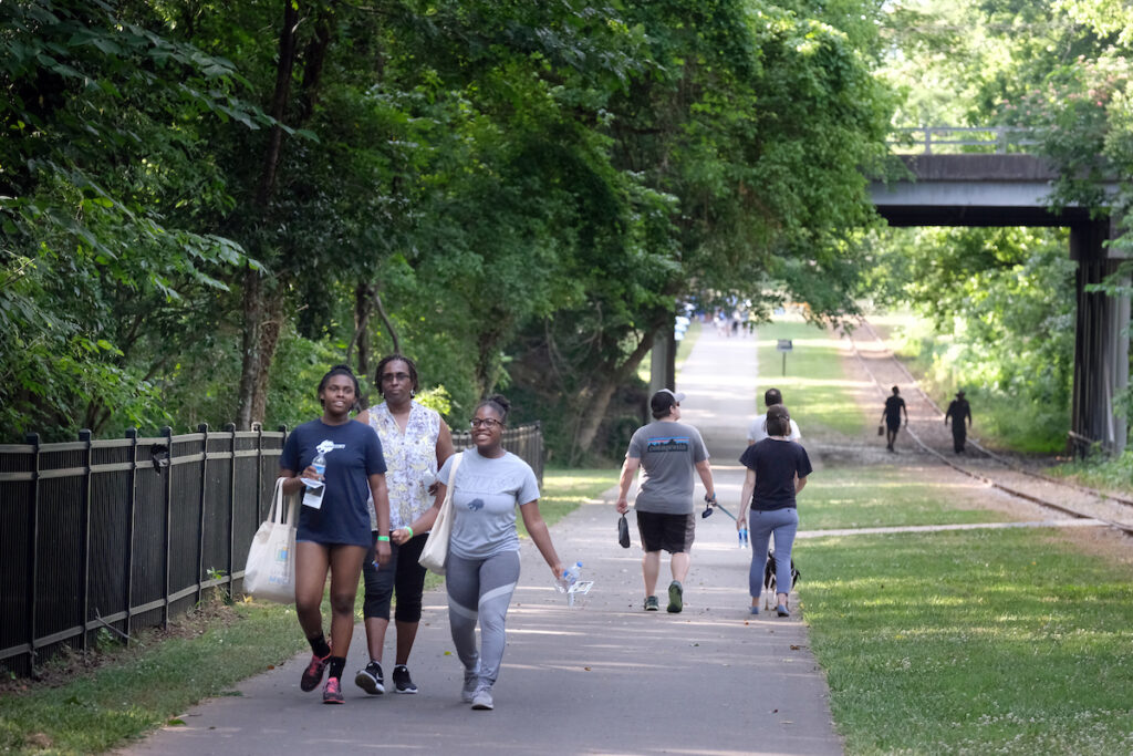 Groups of people enjoy a walk on Stewart Creek Greenway