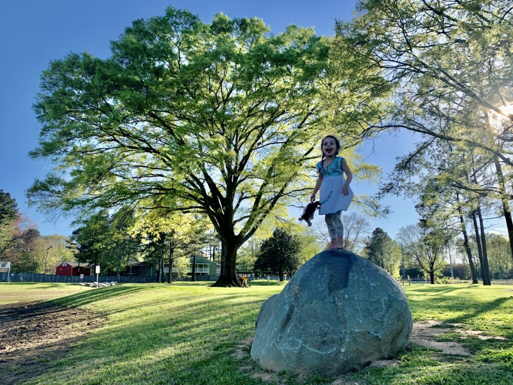 girl on rock in park