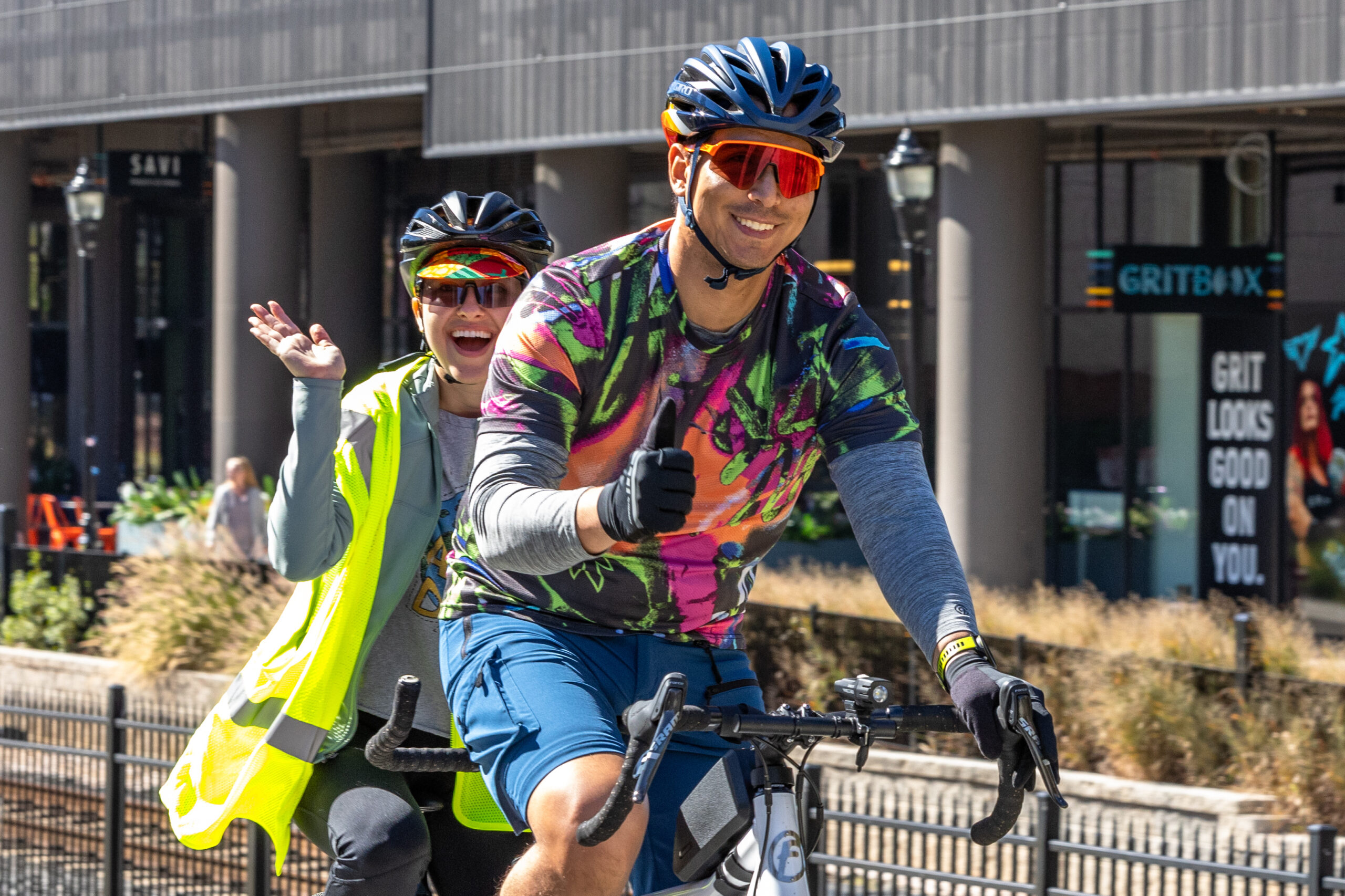 Sustain Charlotte's Biketoberfest, 2023, Two riders smile and wave on bikes