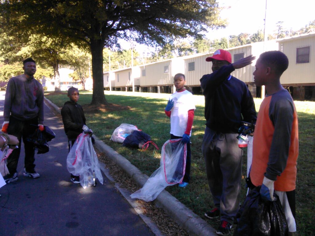  Youth and an adult mentor planned how to clean the grounds of Reid Park Academy.