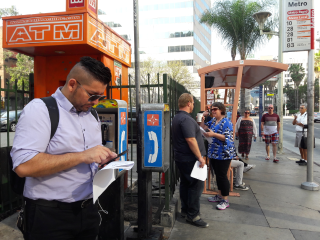 This bus stop in LA gets very crowded during rush hour and it's hard to walk past.